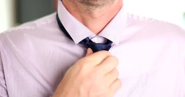 Man putting on blue tie over his shirt closeup 4k movie slow motion. Work dress code business style concept - Footage, Video
