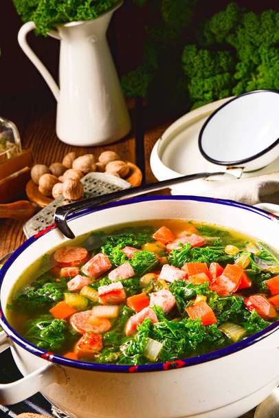 autumnal kale soup with sausage and bacon cubes - Valokuva, kuva