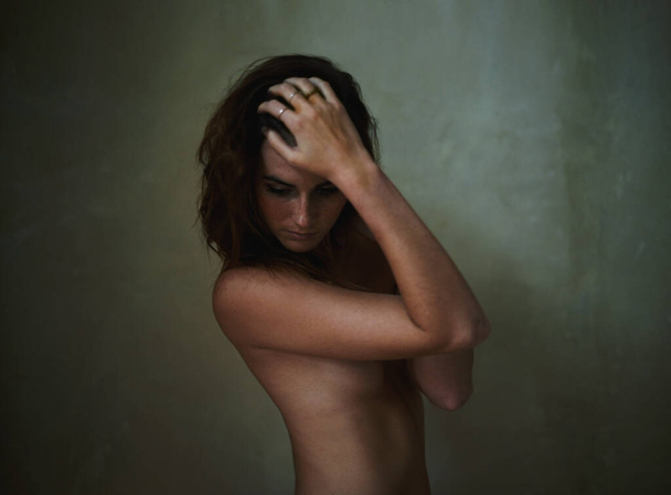Pensive yet beautiful. Young nude woman looking away pensively - Photo, image