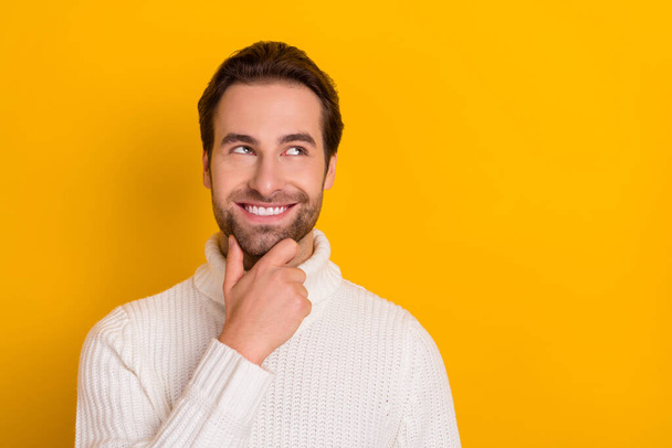 Photo of playful guy finger chin look empty space imagine trick wear white pullover isolated yellow color background. - Fotoğraf, Görsel