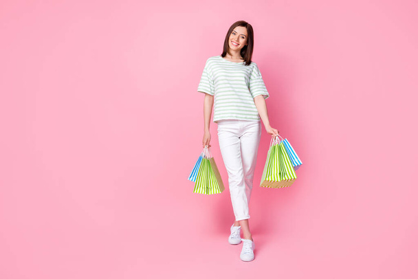 Portrait of pretty gorgeous sweet girl with bob hairdo dressed striped t-shirt hold shopping bag isolated on pink color background. - Fotografie, Obrázek