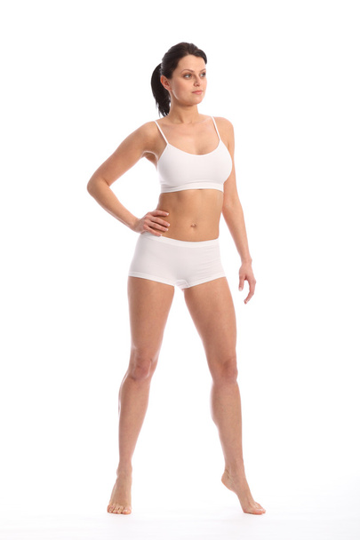 Beautiful fit young woman standing white underwear - Fotó, kép