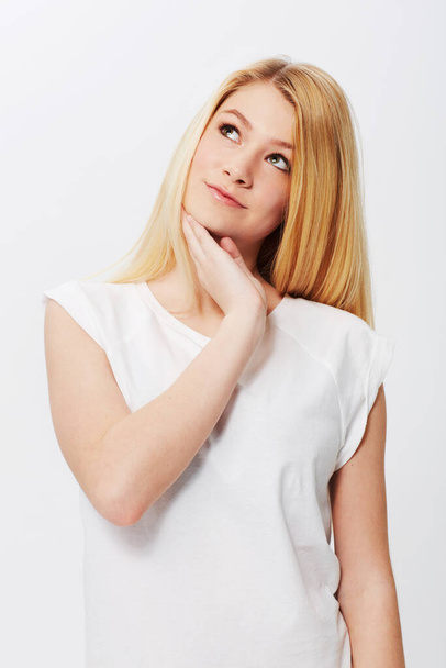 Natural, young and absolutely gorgeous. A pretty young blonde isolated on a white background - Фото, зображення