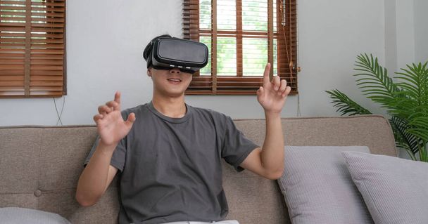 young asian man touching the air during the VR experienc - Фото, изображение
