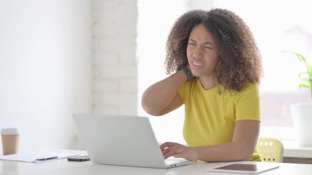 Young African Woman having Neck Pain while using Laptop in Office - Foto, Bild