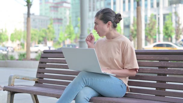 Young Indian Woman Coughing while using Laptop Outdoor - Photo, Image
