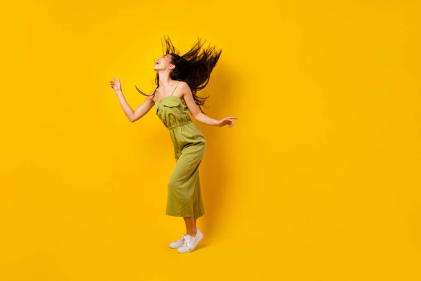 Full body photo of gorgeous peaceful person dancing clubbing empty space isolated on yellow color background. - Fotó, kép