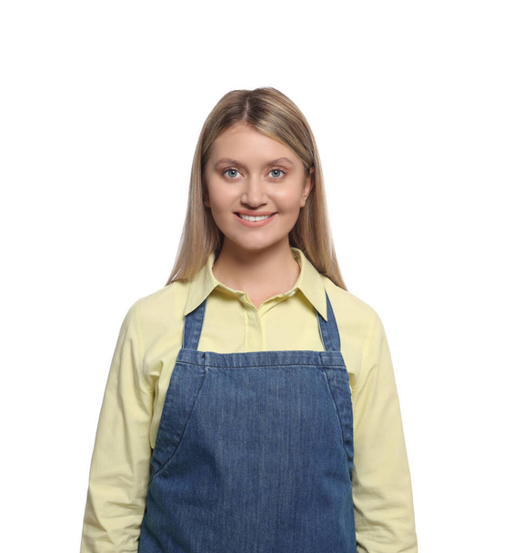 Beautiful young woman in denim apron on white background - Photo, Image