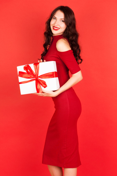 Beautiful woman holding gift box with blue ribbon - Photo, Image