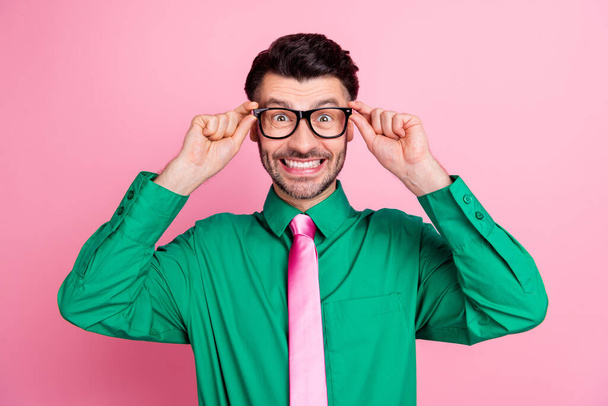 Closeup photo of young smiling funny guy hold eyeglasses looking you happy grimace toothy isolated on pink color background. - Foto, Bild