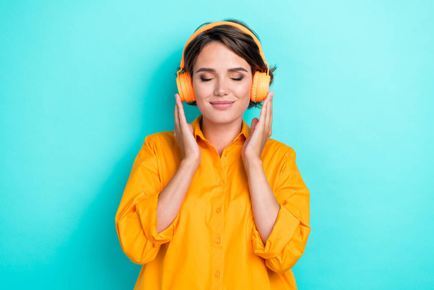 Photo of young pretty attractive cute nice woman girlish closed eyes dreamy listen headphones music comfort isolated on aquamarine color background. - Fotoğraf, Görsel