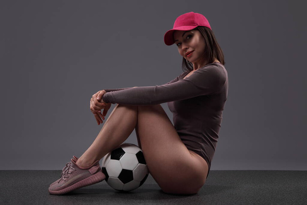 young woman with soccer ball on black background - Photo, image