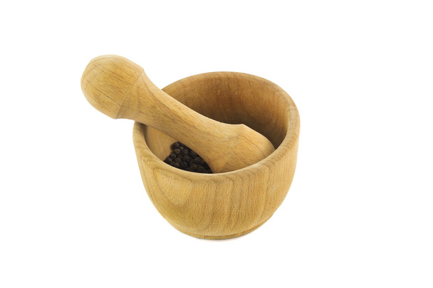 wooden mortar and pestle with black pepper isolated over white - Photo, Image