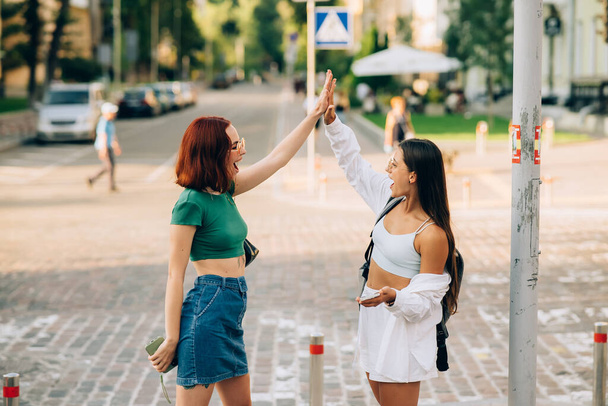 Two University students high five to teach others after successful work together - Foto, imagen