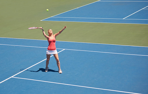 She spends everyday on the court. A young female tennis player out on the court - Photo, Image