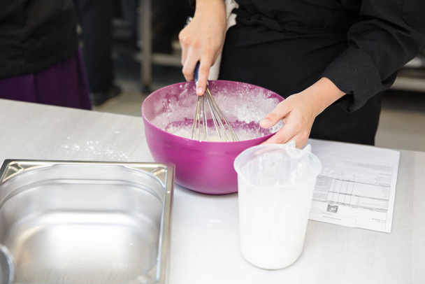 Baker making pastries using flour - Foto, imagen