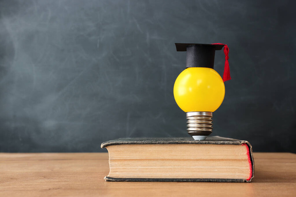 Education concept image. Creative idea and innovation. light bulb metaphor over blackboard background - Foto, Imagen