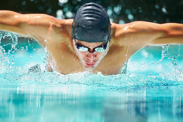 Perfect butterfly stroke. a male swimmer doing the butterfly stroke toward the camera - Photo, Image