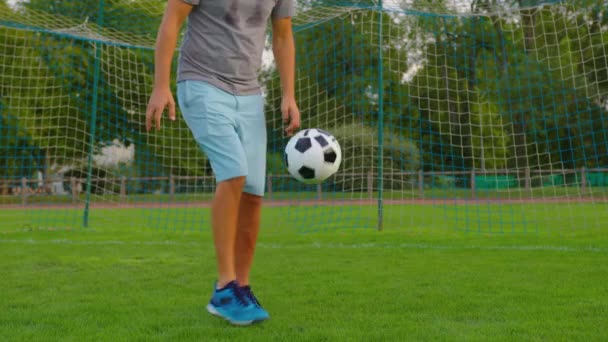 Sportsman is in control of ball. Boy with soccer ball. Boy juggles soccer ball. Child dream of football match. Sports training in park. Child juggles ball. Healthy lifestyle. High quality 4k footage - Footage, Video