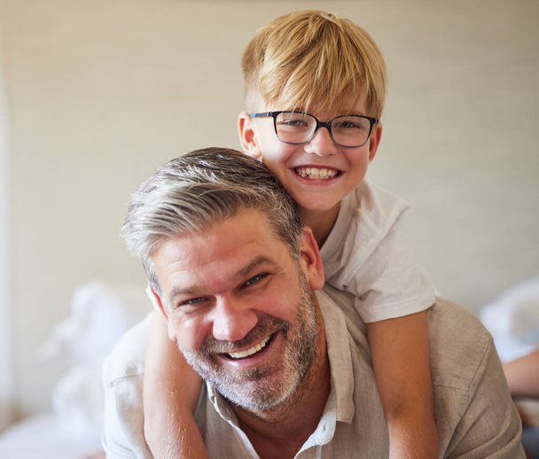 Family, children and love with a man and his child at home, laughing and having fun with a smile together. Kids, happy and smile with a cute boy and his father playing in a bedroom of their house. - Photo, image