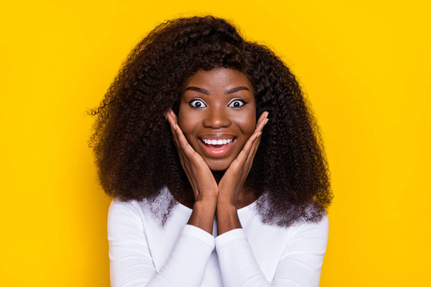 Photo of impressed excited girl arms touch cheeks toothy smile unbelievable isolated on yellow color background. - Fotoğraf, Görsel