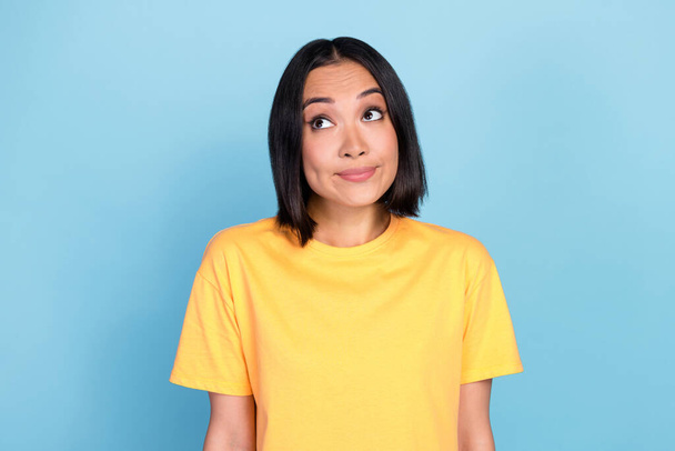 Portrait of nice pretty lovely woman with bob hairdo dressed yellow t-shirt guilty look empty space isolated on blue color background. - 写真・画像