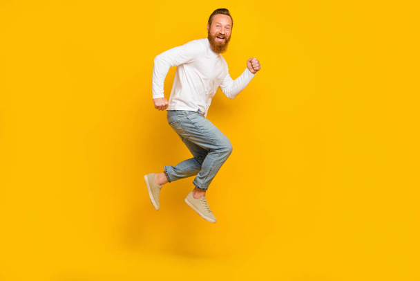 Full length profile photo of beard man run wear shirt jeans shoes isolated on yellow color background. - Valokuva, kuva