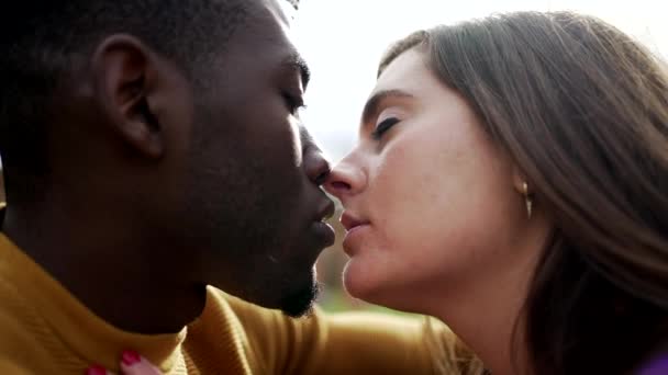 Young interracial couple kissing outside. Black man with white girlfriend kiss, diversity concept - Footage, Video