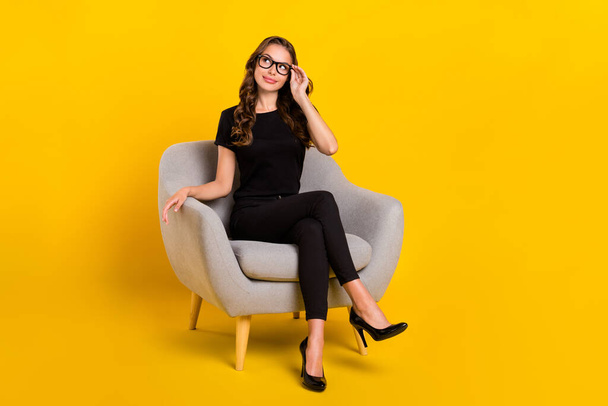 Full size photo of young pretty woman interested look empty space sit comfort recruiter isolated over yellow color background. - Fotoğraf, Görsel