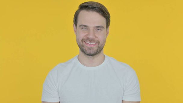Approval by Casual Young Man, Shaking Head on Yellow Background - Foto, Imagen