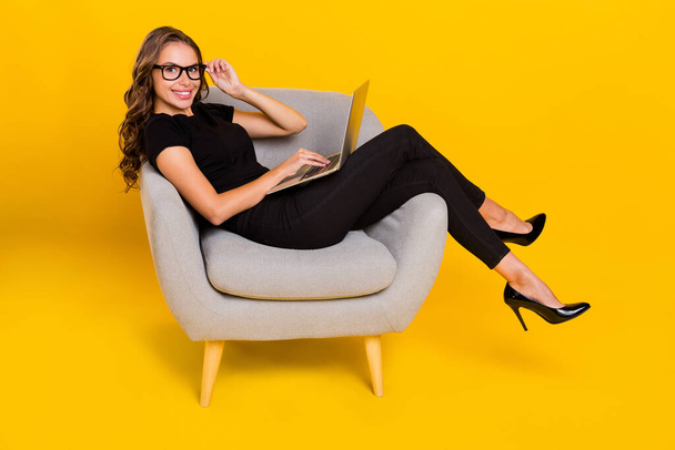 Full body profile side photo of young pretty woman use laptop agent manager isolated over yellow color background. - Fotografie, Obrázek