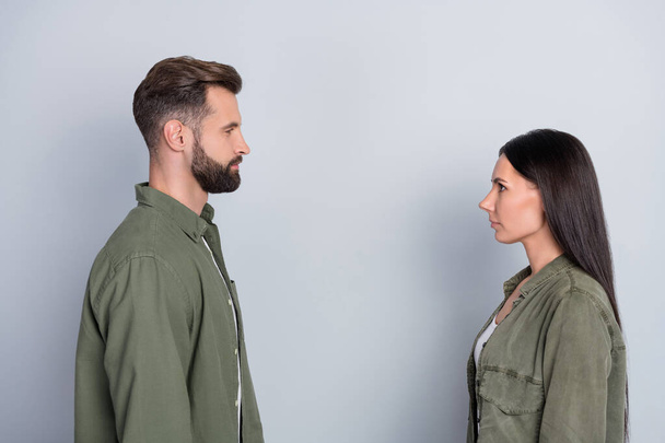 Profile side view portrait of attractive confident couple looking at each other isolated over grey pastel color background. - Φωτογραφία, εικόνα