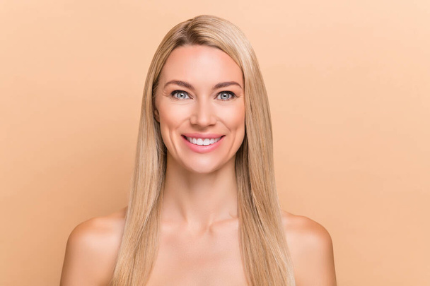 Portrait of attractive cheerful blond hair woman perfect smooth silky skin laser peeling effect isolated over beige pastel color background. - Fotografie, Obrázek