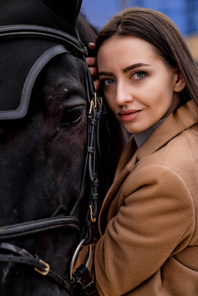 Brunette beautiful woman portrait with horse. Pretty lady model with horse. - Photo, Image