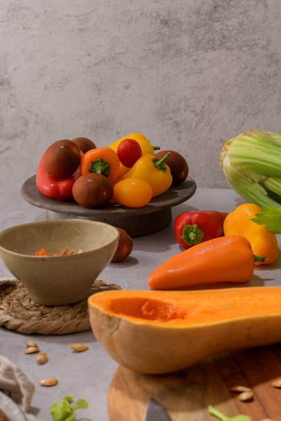 Autumn vegetables arranged on a kitchen worktop while preparing a pumpkin soup. - Photo, image