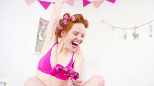 Red-haired girl playing video game - Footage, Video