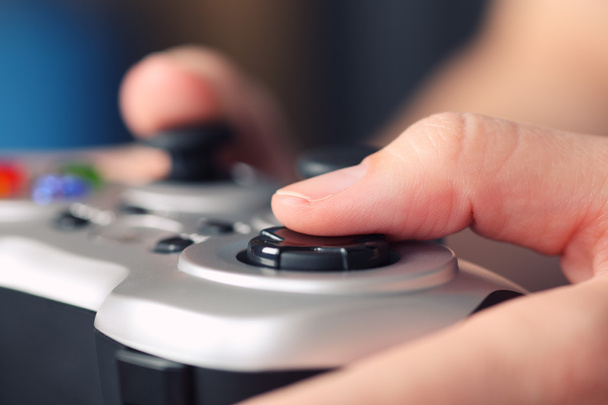 Young woman plays video game using a gamepad - Foto, Imagem