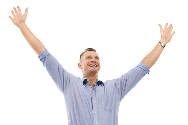 I couldnt be any happier. Studio shot of a happy-looking mature man with his arms in the air isolated on white - Fotoğraf, Görsel