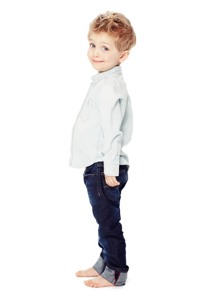 Look how tall Im getting. Side view of a cute little boy standing against a white background - portrait - Foto, Imagen