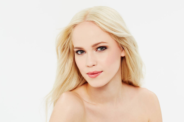 Soft, flawless skin. Portrait of a beautiful blonde against a white background - Photo, Image