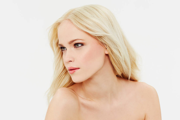 Flawless beauty. a beautiful blonde model looking to the side with a white background - Foto, imagen