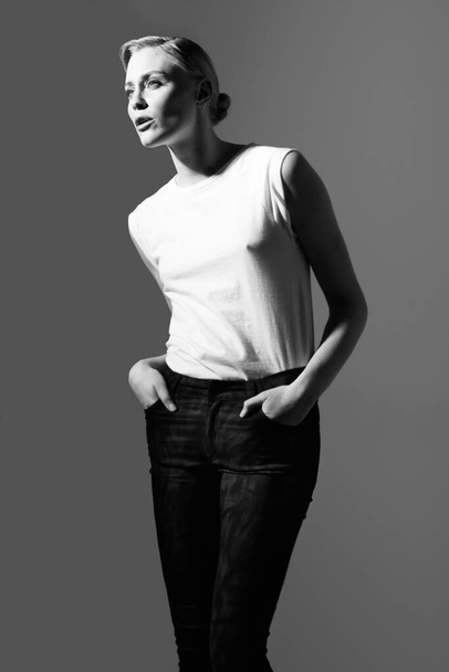 Effortless elegance. Black and white image of a beautiful woman posing in casual wear - Zdjęcie, obraz