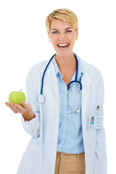 You know what they say about an apple a day...A young smiling doctor holding a green apple - Fotografie, Obrázek