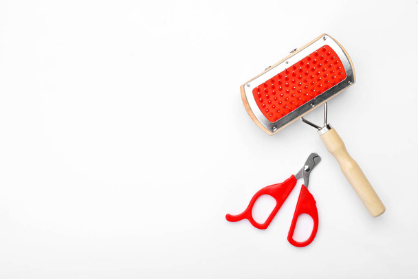 Grooming brush and nail clipper on white background - Photo, Image