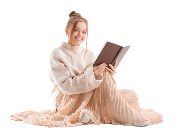 Pretty young woman with book sitting on white background - Zdjęcie, obraz