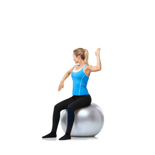 Toning up for Summer. a woman sitting on an exercise ball while toning her arms - Φωτογραφία, εικόνα