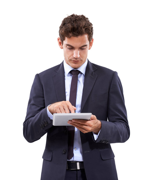 Hes always connected. A handsome young businessman typing on his digital tablet - Foto, afbeelding