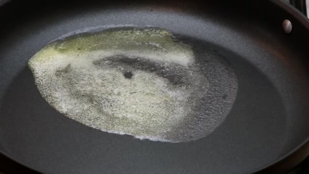 Melting the butter in a frying pan, time lapse - Footage, Video