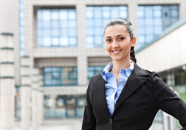 Businesswoman standing in front of office building - Fotografie, Obrázek