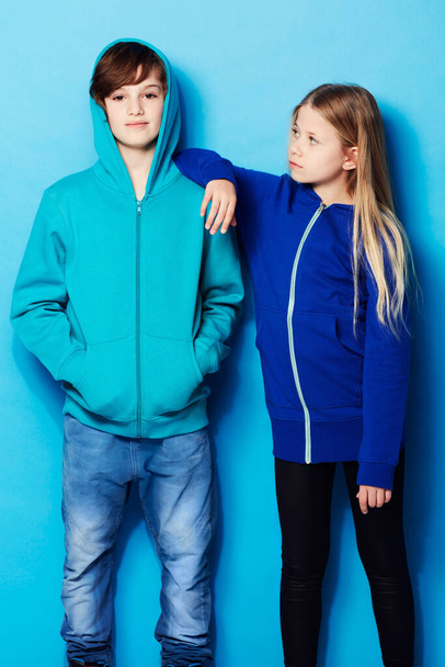 Hes too cool. Portrait of a young boy with a young girl leaning on him in the studio - Fotografie, Obrázek